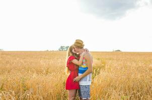 Stunning sensual portrait of young stylish fashion man and woman posing in field photo