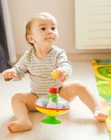 funny boy kid playing with toy photo