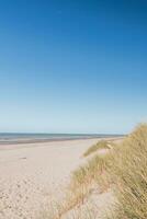 Typical beach on the Atlantic coast of Belgium during daylight hours. A place of relaxation and rest. Spending your free time photo