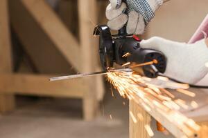 cutting metal with angle grinder, sparks from the disk. photo