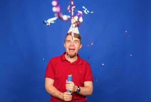 joven gracioso hombre celebrando nuevo año y Navidad fiesta con papel picado foto