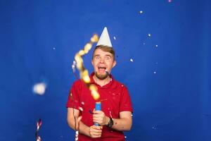 Young funny man with confetti. Holidays, carnival, christmas and new year party concept photo