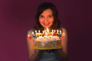 Portrait of pretty girl holding birthday cake photo