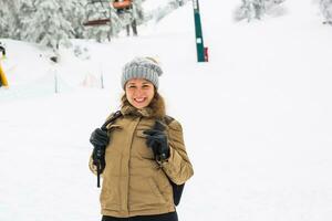 Happy traveler woman with a backpack in winter time photo