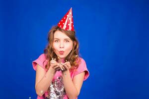 Beautiful young woman having fun with confetti in studio. New year, christmas, carnival and holidays concept photo