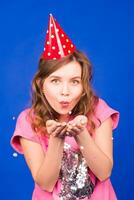 Beautiful young woman having fun with confetti in studio. New year, christmas, carnival and holidays concept photo