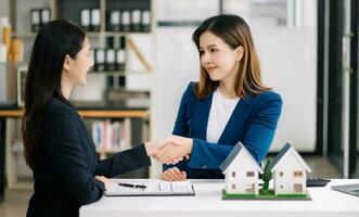 Salesman Hands On House Model , Small Toy House Small Mortgage Property insurance and concepts real estate photo