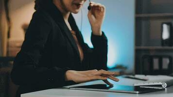 Young woman working in call centre, surrounded by colleagues video