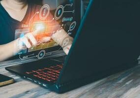 A male entrepreneur, using a laptop, connects to the internet and showcases graphics that extend beyond the screen, creating a hologram-like display that captivates his audience. photo