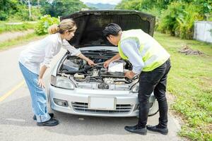 Closeup and crop motor vehicle mechanic checking engine according to customer orders on roadside. photo