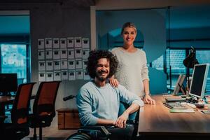 a man and woman in a wheelchair in an office photo