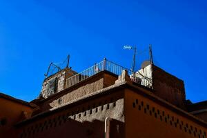 the roof of an old building against a blue sky photo