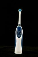 an electric toothbrush is shown on a black background photo