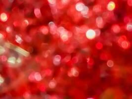 Blurred and bokeh red reflection of Christmas decorated background and wallpaper. photo