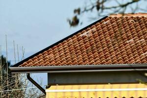 a close up of a roof with a red tile photo