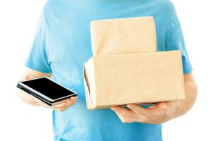 Boxes and tablet in mans hands. Delivery concept. photo