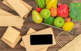 Paper packaging, food and tablet screen photo