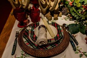 set christmas table with plates and glasses photo