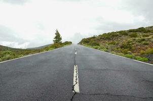 an empty road with white lines on it photo