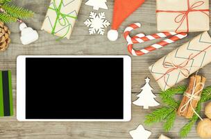 Christmas background with tablet screen and Christmas objects photo