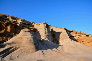 the rock formations in the desert are very large photo