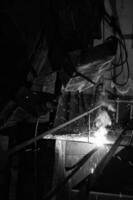 a black and white photo of a man welding