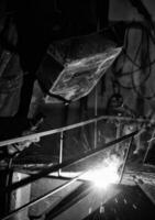 a black and white photo of a man welding