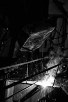 a black and white photo of a man welding