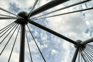 a view of the top of a bridge with clouds in the sky photo