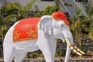 a white elephant statue with red and gold decorations photo