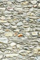 a stone wall with many different types of stones photo