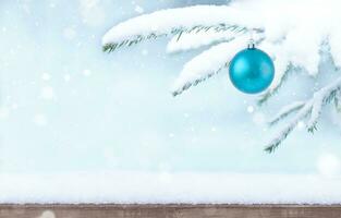 Snowy background with Christmas ornament photo