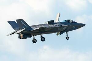 Royal Air Force Lockheed F-35B Lightning II stealth fighter jet plane flying. Aviation and military aircraft. photo