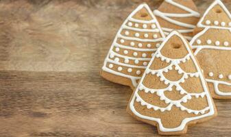 Holiday gingerbread cookies on the wooden background photo