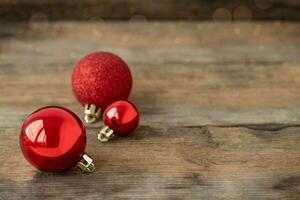 Christmas ornament on the wooden background, three red balls photo