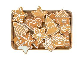 Isolated Christmas gingerbread cookies on the wooden tray photo