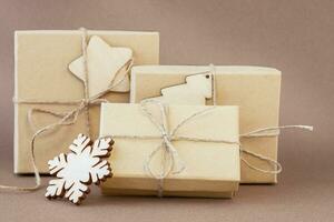 Ecological gifts in three boxes on the brown background photo