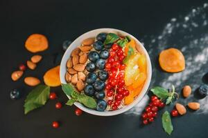 Oatmeal with fruit and almonds photo