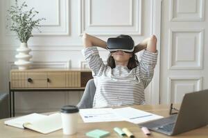 Relaxed woman in VR headset leans back in her chair, immersed in a virtual world photo