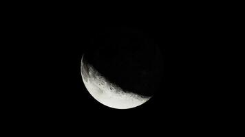 The moon illuminated by the sun in view from above photo