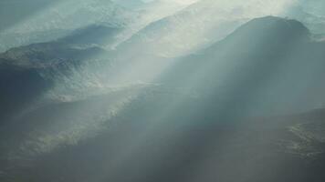 Alpine chains shrouded in the morning fog photo