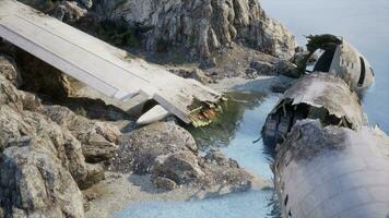 Plane wreck on the beach with rocks near ocean photo