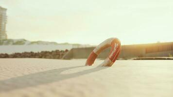 Lifebuoy on the city beach at sunset photo