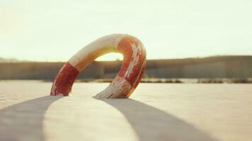 Lifebuoy on the city beach at sunset photo