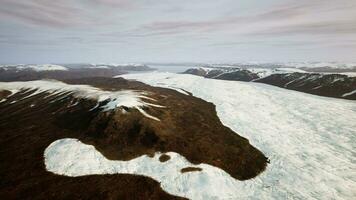 A breathtaking snow-covered mountain range seen from above photo