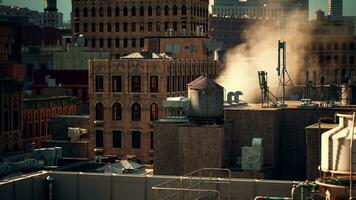 Smoke rising from a chimney on a building's rooftop photo