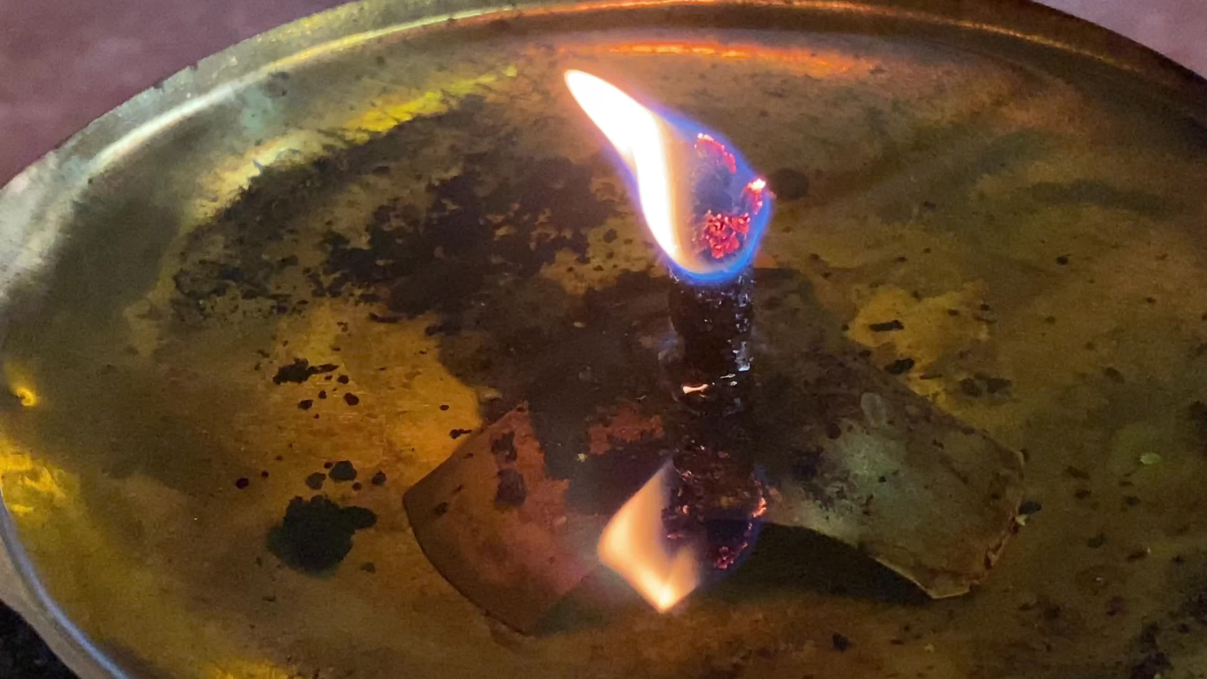 Flames under candlelight for worshiping sacred objects according to