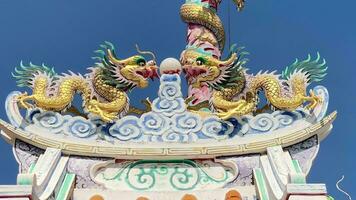 Ang Silla,Chonburi.Thailand -  January 14,2023.Naja statue golden is a beautiful Thai and Chinese architecture of Nachas sa thai chute shrine, naja shrine, najasaataichue, nezha shrine chinese temple. video