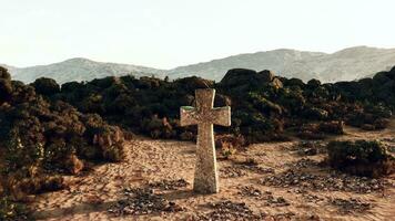 A solitary stone cross in the vast desert landscape photo