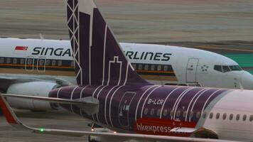 PHUKET, THAILAND FEBRUARY 27, 2023 Boeing 737 Singapore Airlines at Phuket airport. Tractor towing a passenger plane. Apron, terminal video